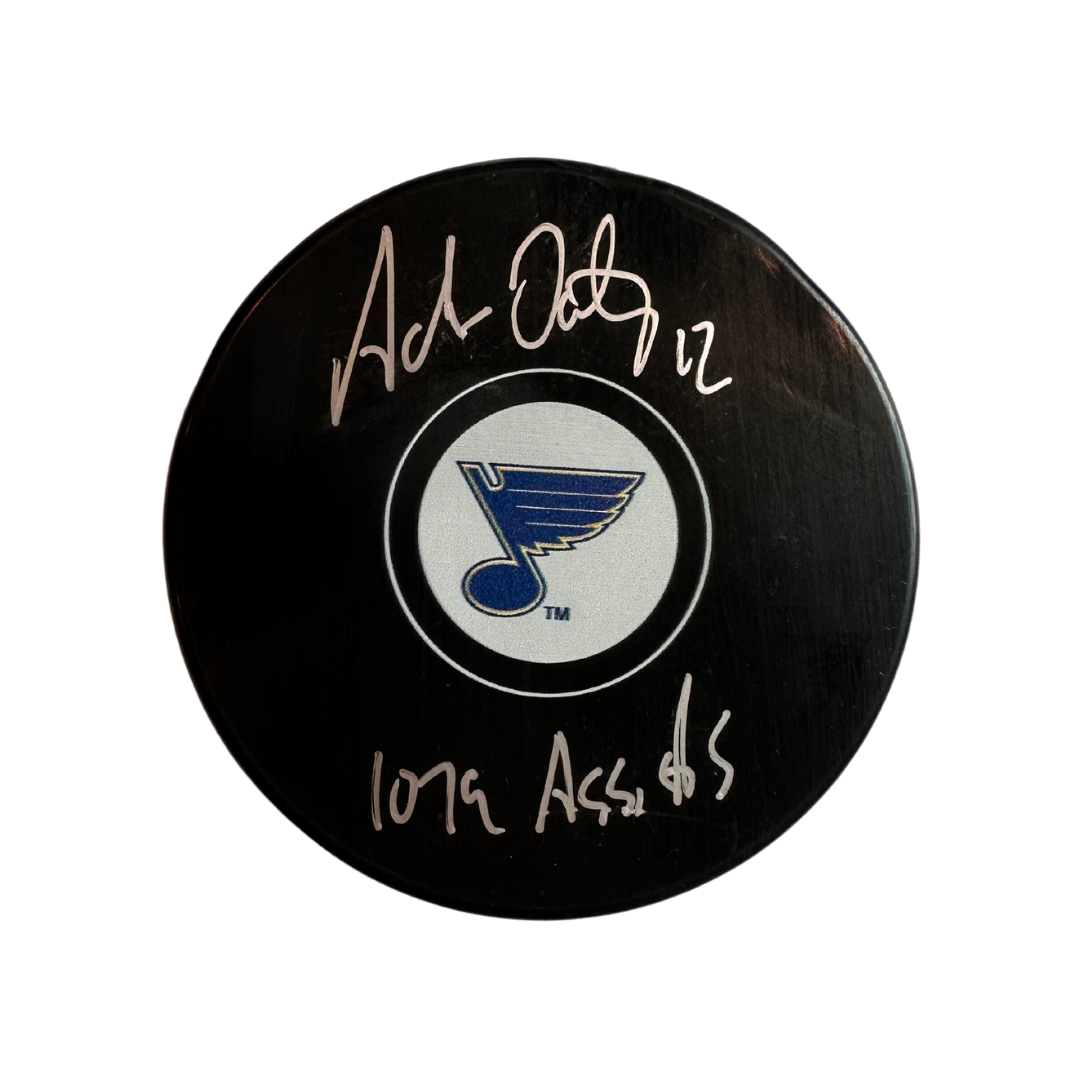 Adam Oates St Louis Blues Autographed Logo Puck w/ "1079 Assists" Inscription - Fan Cave COA